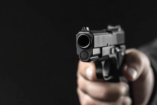 a person holding a gun in their hand photo